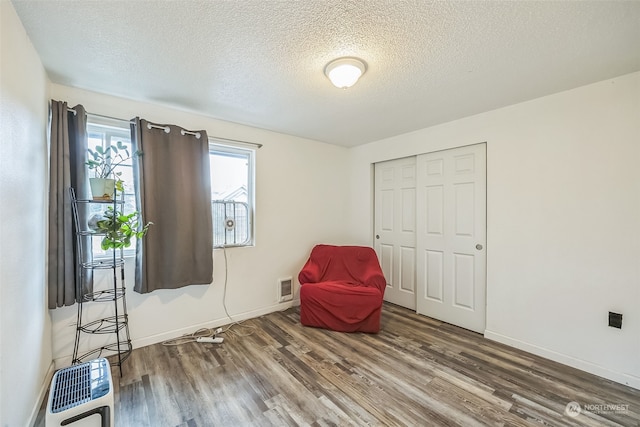 unfurnished room featuring hardwood / wood-style floors and a textured ceiling