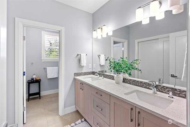 bathroom with tile patterned flooring, vanity, and decorative backsplash