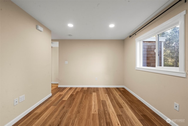 empty room with hardwood / wood-style floors