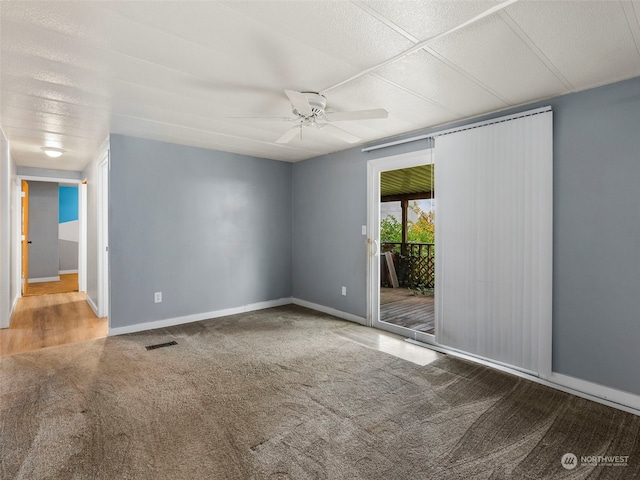 spare room featuring carpet floors and ceiling fan