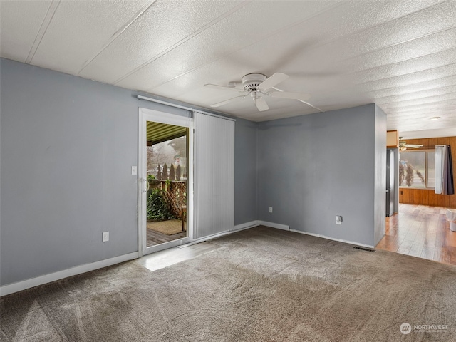 empty room featuring ceiling fan, hardwood / wood-style floors, and a textured ceiling