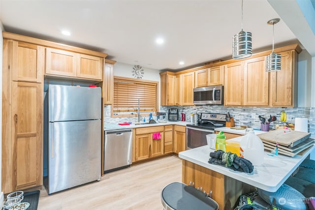 kitchen featuring a kitchen breakfast bar, light hardwood / wood-style flooring, appliances with stainless steel finishes, tasteful backsplash, and decorative light fixtures