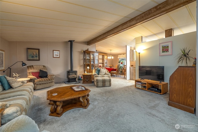 living room featuring vaulted ceiling with beams, a wood stove, and carpet floors