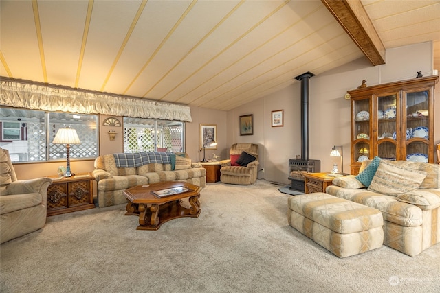 living room featuring carpet flooring, a wood stove, and vaulted ceiling with beams