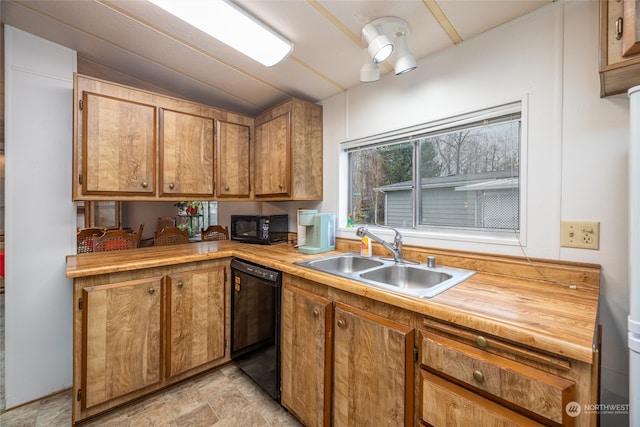 kitchen featuring sink, black appliances, lofted ceiling, and wooden counters