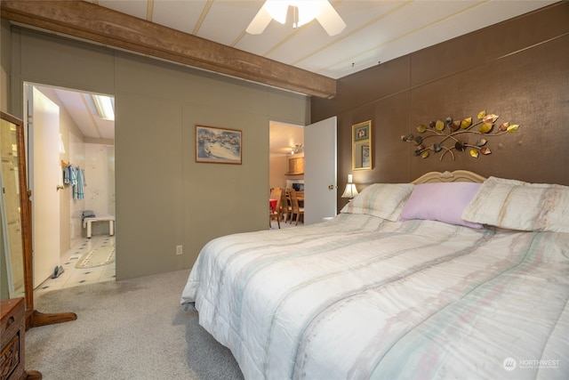 carpeted bedroom with beamed ceiling and ceiling fan