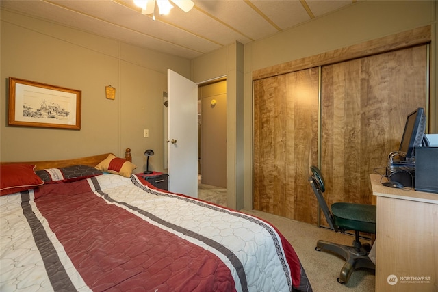 carpeted bedroom with ceiling fan and a closet