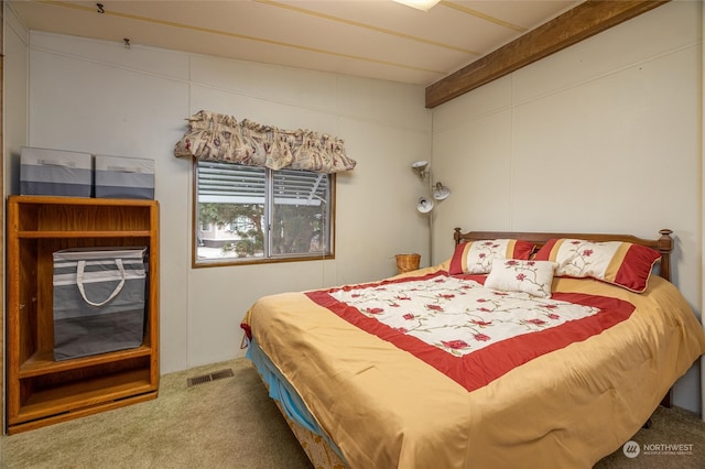 bedroom featuring beamed ceiling and carpet floors