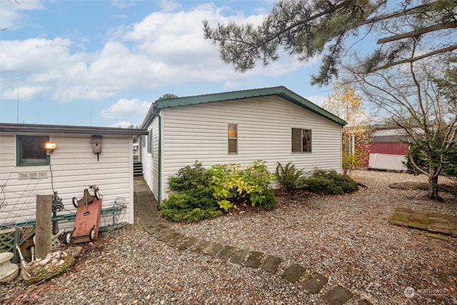 view of property exterior featuring a shed