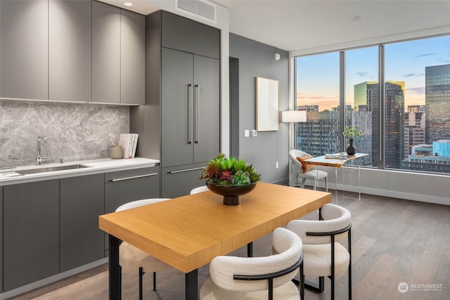 dining space featuring sink and light hardwood / wood-style flooring