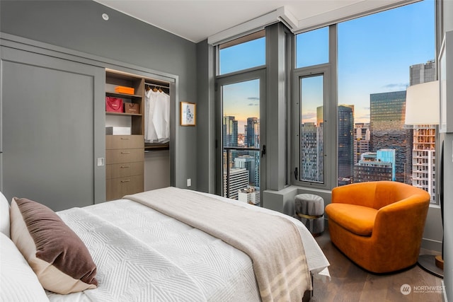 bedroom with hardwood / wood-style flooring and a closet