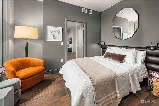 bedroom with dark wood-type flooring and a closet