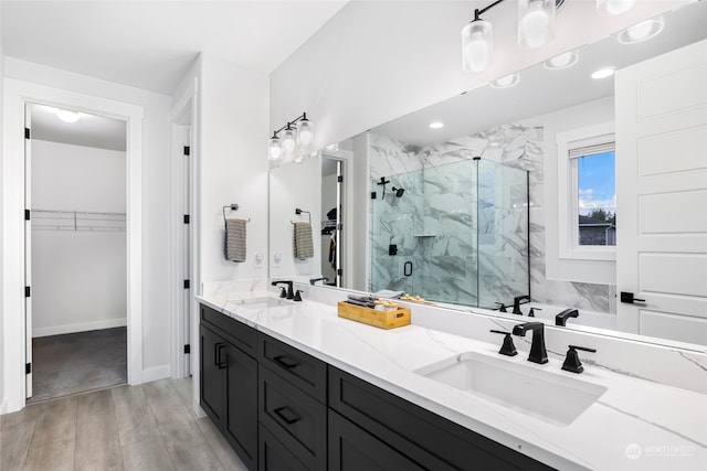 bathroom with vanity, an enclosed shower, and wood-type flooring