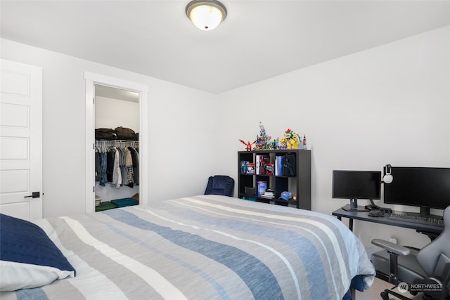 bedroom featuring carpet flooring, a spacious closet, and a closet