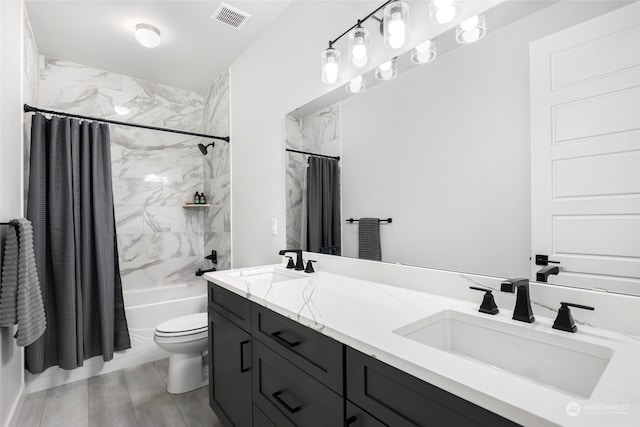 full bathroom featuring vanity, hardwood / wood-style flooring, toilet, and shower / bathtub combination with curtain