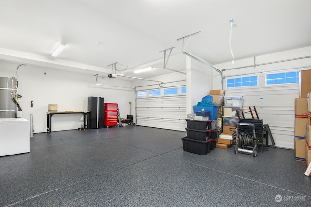 garage with secured water heater and a garage door opener