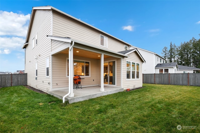 rear view of property featuring a patio and a lawn