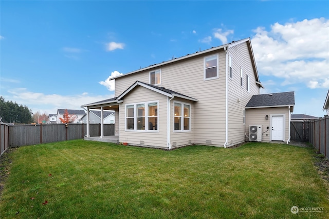 rear view of property featuring a patio and a lawn