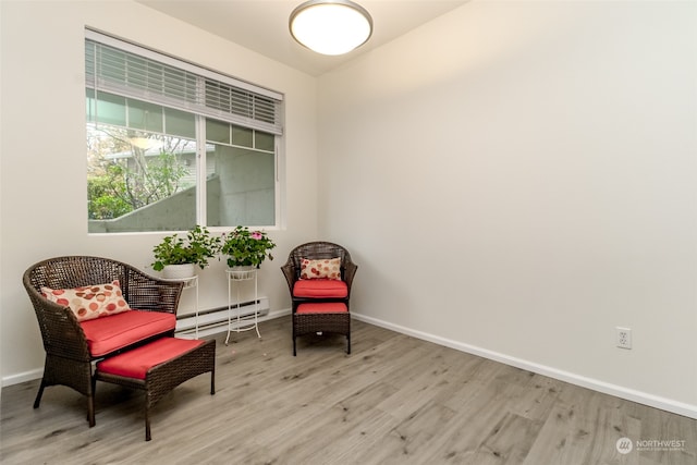 sitting room featuring light hardwood / wood-style floors and a baseboard radiator