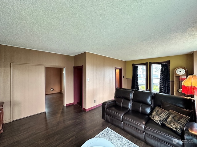 living room featuring a textured ceiling and dark hardwood / wood-style flooring