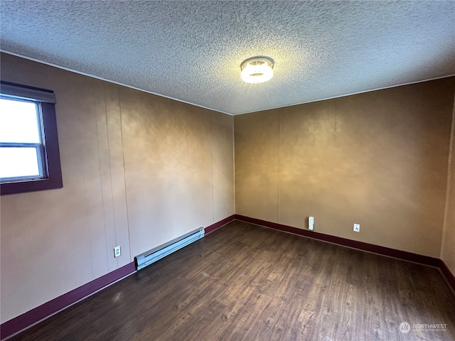 empty room featuring a textured ceiling, dark hardwood / wood-style flooring, baseboard heating, and wooden walls