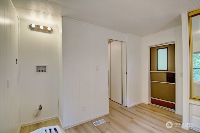 laundry room featuring light hardwood / wood-style floors and washer hookup