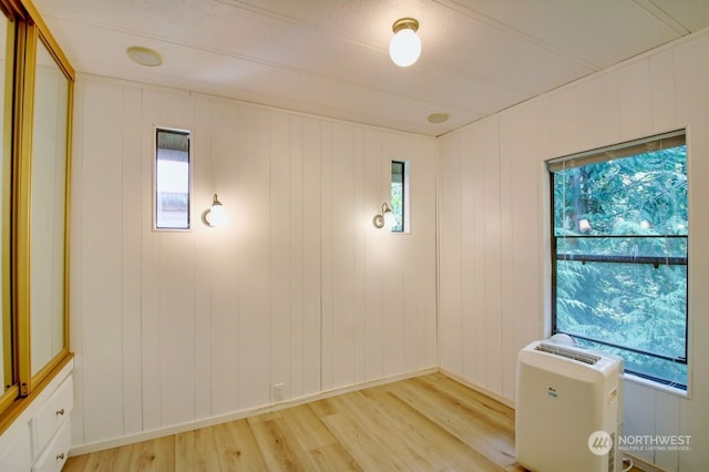 empty room with a wealth of natural light and hardwood / wood-style floors