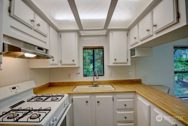 kitchen featuring white cabinets, white range with gas stovetop, and sink