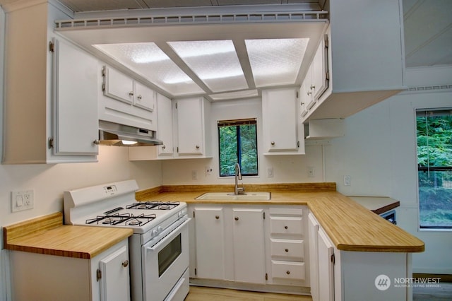 kitchen with white cabinets, white range, sink, light hardwood / wood-style floors, and extractor fan