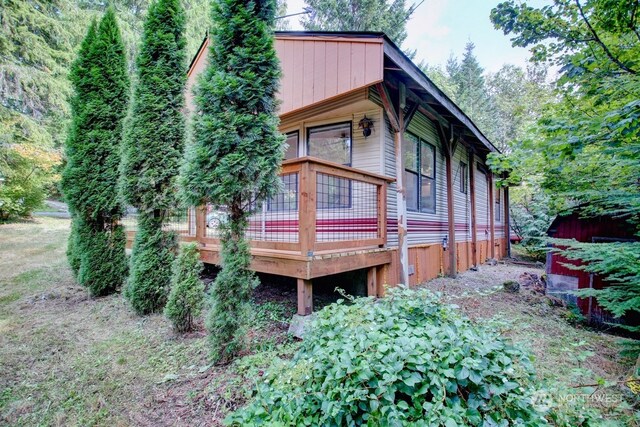 rear view of property featuring a wooden deck