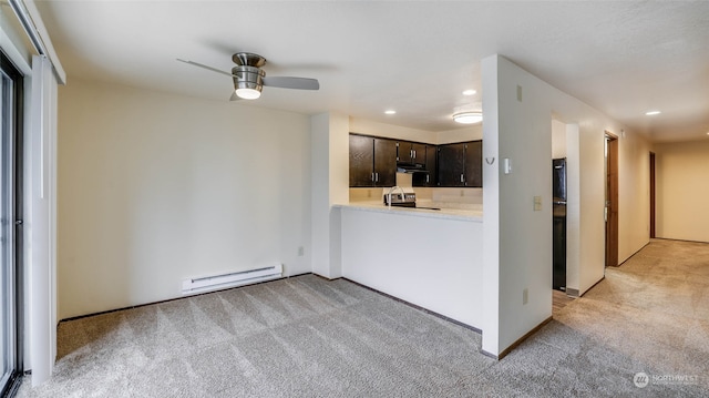 kitchen featuring dark brown cabinetry, stainless steel range, a baseboard heating unit, kitchen peninsula, and light carpet