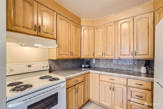 kitchen with tasteful backsplash, tile counters, white appliances, and light brown cabinets