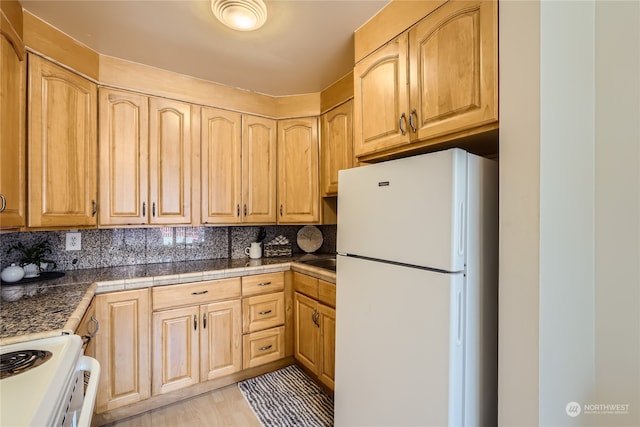 kitchen featuring decorative backsplash, light wood-type flooring, white appliances, and light brown cabinetry