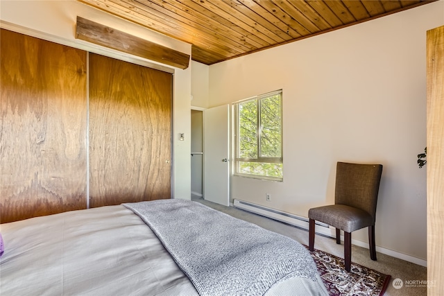 carpeted bedroom featuring a baseboard radiator and wood ceiling