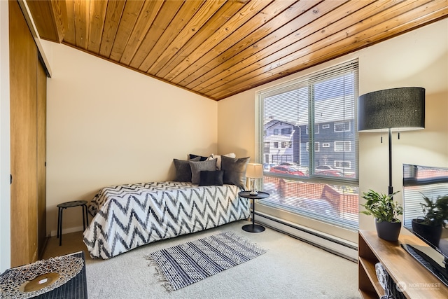 carpeted bedroom featuring vaulted ceiling, a baseboard heating unit, and wood ceiling