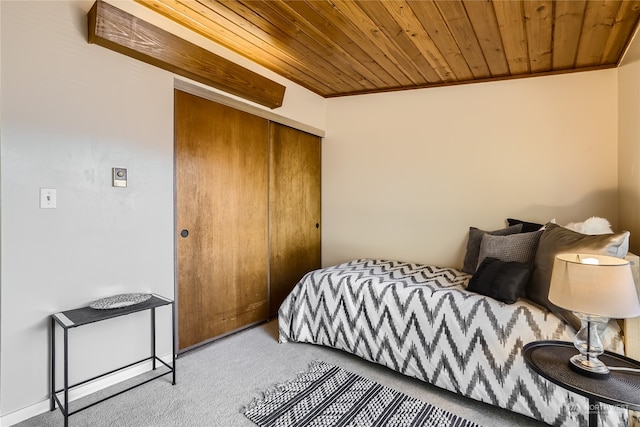 bedroom with crown molding, a closet, light colored carpet, and wooden ceiling