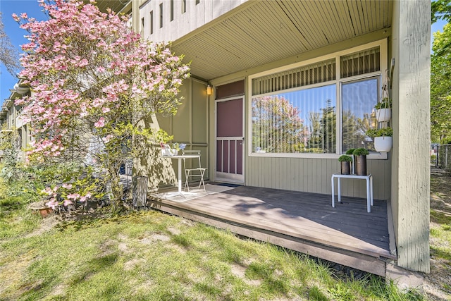 view of exterior entry with a deck