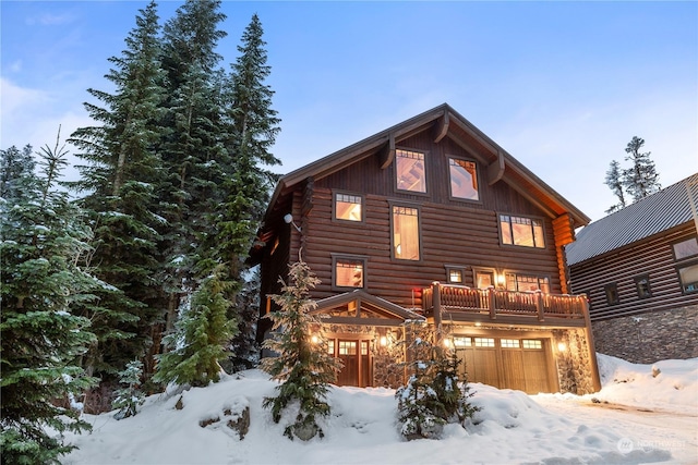 log-style house featuring a garage