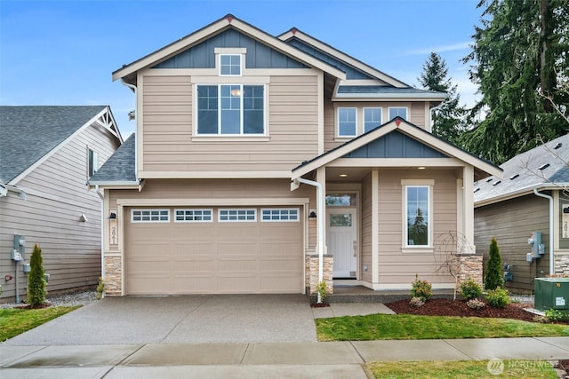 craftsman-style home featuring central AC and a garage