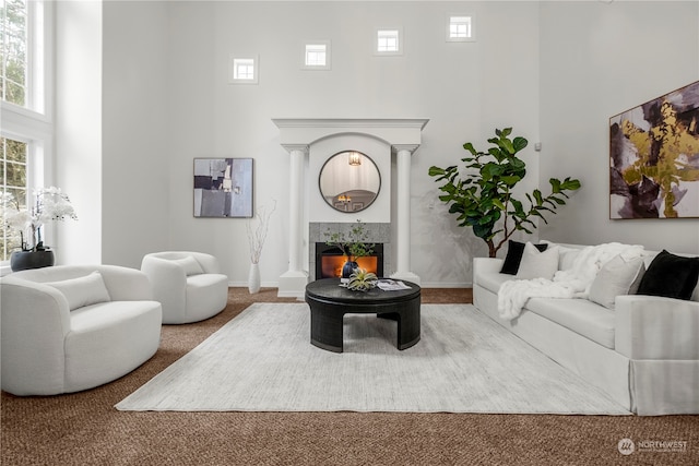 carpeted living room with a towering ceiling