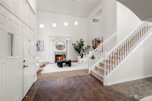 entryway featuring a towering ceiling