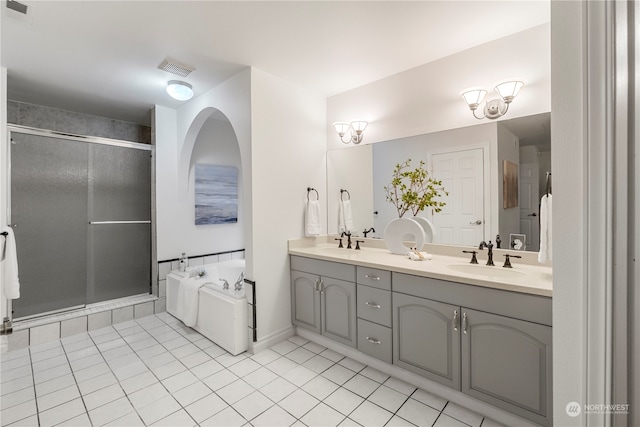 bathroom featuring vanity, tile patterned flooring, and plus walk in shower