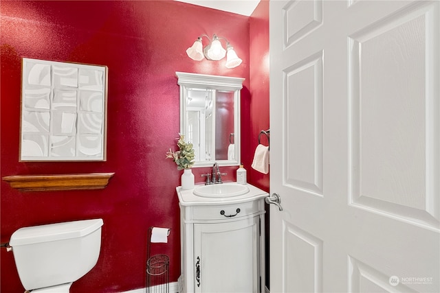 bathroom featuring vanity and toilet