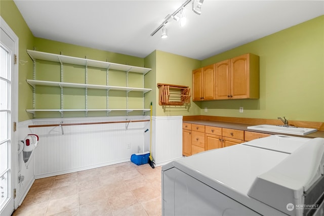 laundry area with sink, light tile patterned flooring, cabinets, and independent washer and dryer