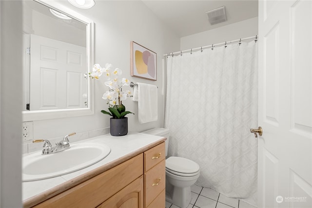 bathroom featuring tile patterned flooring, vanity, and toilet