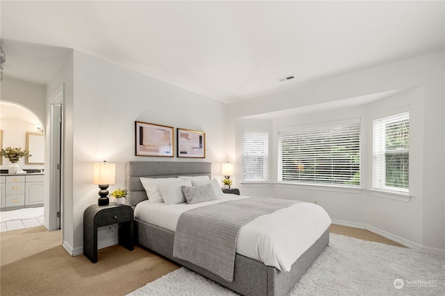 carpeted bedroom with ensuite bathroom