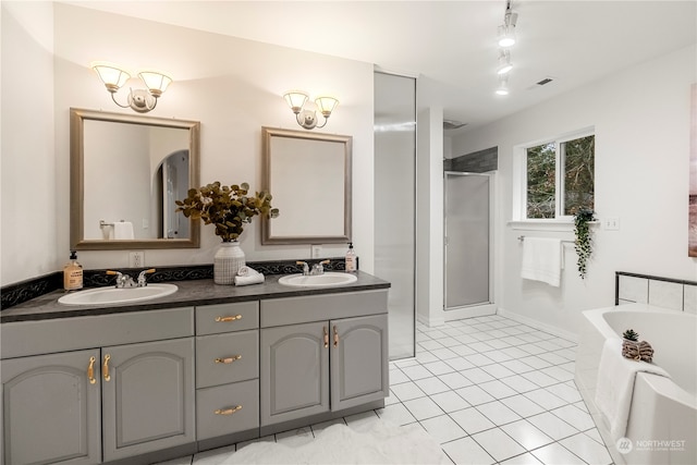 bathroom featuring tile patterned flooring, vanity, rail lighting, and separate shower and tub