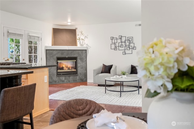 living room featuring a tile fireplace