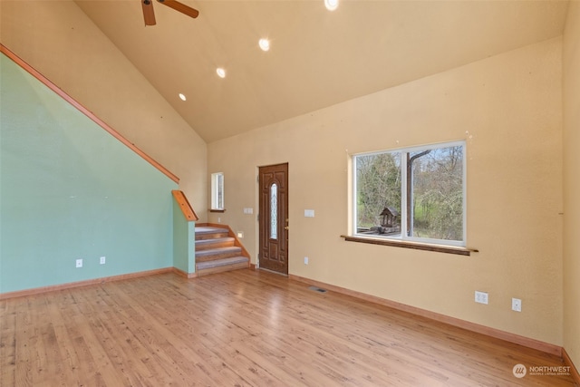 unfurnished living room featuring ceiling fan, light hardwood / wood-style flooring, and high vaulted ceiling