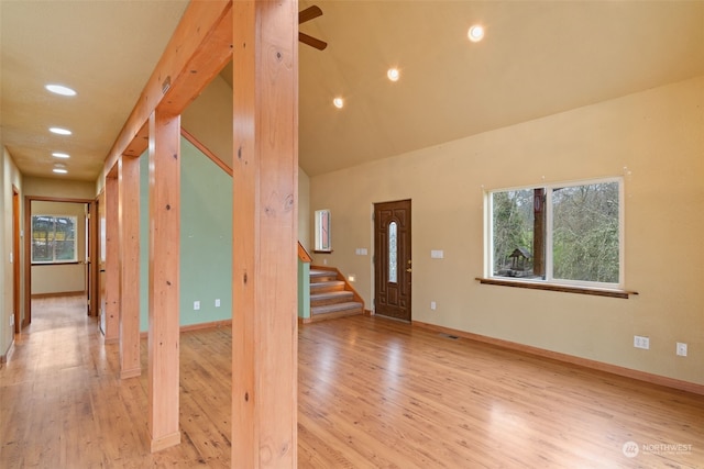 interior space with ceiling fan, light hardwood / wood-style floors, and high vaulted ceiling